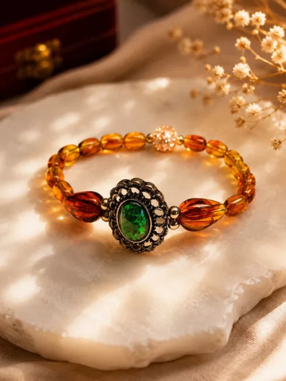 Vintage Style Amber Bead Bracelet With Green Cabochon Centrepiece